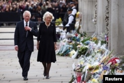 Britain's King Charles and Queen Camilla walk outside Buckingham Palace, following the passing of Britain's Queen Elizabeth, in London, Britain, September 9, 2022. REUTERS/Henry Nicholls