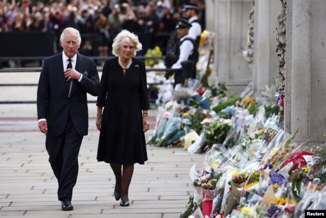 Britain's King Charles and Queen Camilla walk outside Buckingham Palace, following the passing of Britain's Queen Elizabeth, in London, Britain, September 9, 2022. REUTERS/Henry Nicholls