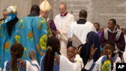 Faithful dance and sing in front of Pope Francis as he celebrates a Mass for the Congolese Catholic community of Rome in St. Peter's Basilica at the Vatican, Dec. 1, 2019.