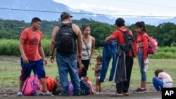 Migrants pause on the shoulder of a road on the outskirts of Tapachula, Chiapas state, Mexico, Nov. 20, 2024, during their journey to the U.S. border.