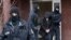 Police officers escort a suspect during a raid in Berlin, Germany, March 3, 2020.