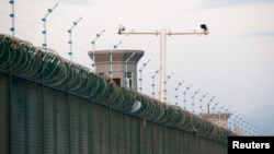 Security cameras are installed above the perimeter fence of what is officially known as a vocational skills education center in Dabancheng, in Xinjiang Uighur Autonomous Region, China, Sept. 4, 2018. 