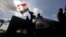 Egyptian protesters celebrate the capture of a state security armored vehicle that demonstrators commandeered during clashes with security forces and brought to Tahrir Square in Cairo, January 29, 2013. 