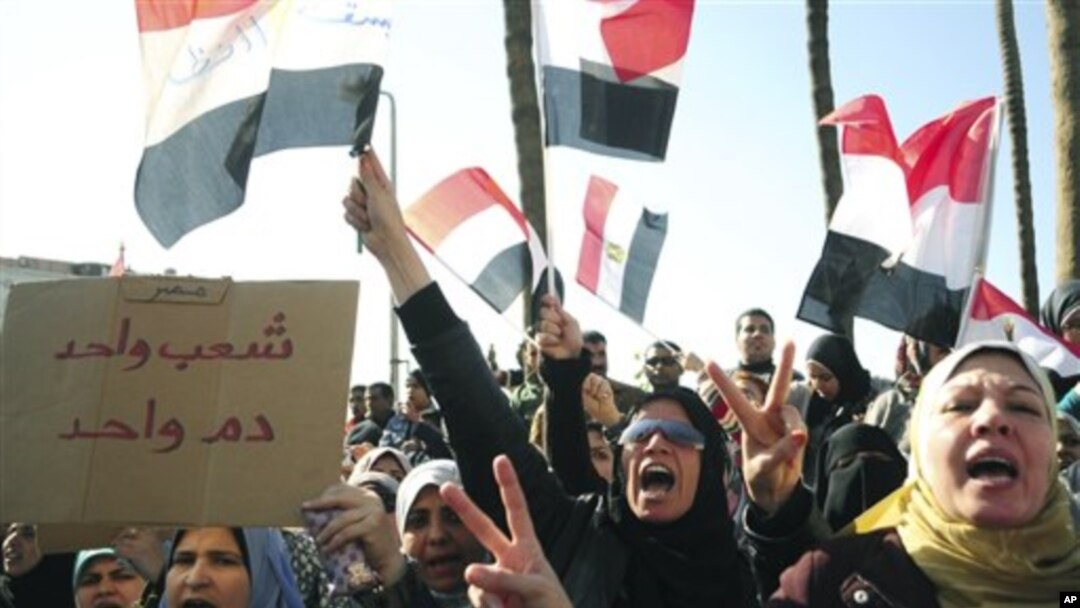 Egyptian anti-Mubarak protesters shout slogans as they march in Alexandria, Egypt, Feb 8, 2011