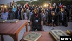 New Somali parliamentarians pray during an inauguration ceremony for members of Somalia's first parliament in 20 years, in Mogadishu, August 20, 2012.