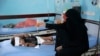 FILE - A mother holds up a feeding tube for her malnourished son at a feeding center in a hospital in Hodeida, Yemen, Sept. 27, 2018. 