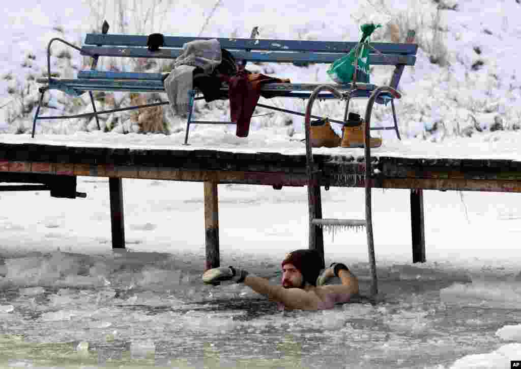 A man bathes in the icy water of the Dziekanowskie Lake near Lomianki, Poland, in temperatures as low as -12&#176; C (10&#176; F).