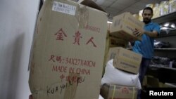 A worker arranges boxes at a shop in Chinatown in Panama City, Panama, June 13, 2017. 