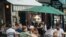 FILE - People dine outside at a restaurant in the West Village neighborhood in New York City, July 5, 2020. 