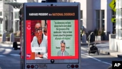 A truck along a street December 12, 2023, near Harvard University, in Cambridge, Mass. The truck displays messages calling attention to a recent controversy involving testimony to Congress by the presidents of Harvard University, MIT, and the University of Pennsylvania.