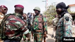 Lieutenant-Colonel Issiaka Ouattara, named Wattao, and Lieutenant-Colonel Cherif Ousmane greet mutinous soldiers, at the airport in Bouake, Ivory Coast, Jan. 13, 2017. 