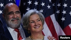 Campaign co-chairs Susie Wiles and Chris LaCivita listen as Donald Trump speaks at his election night rally at the Palm Beach County Convention Center in West Palm Beach, Florida, on Nov. 5, 2024.