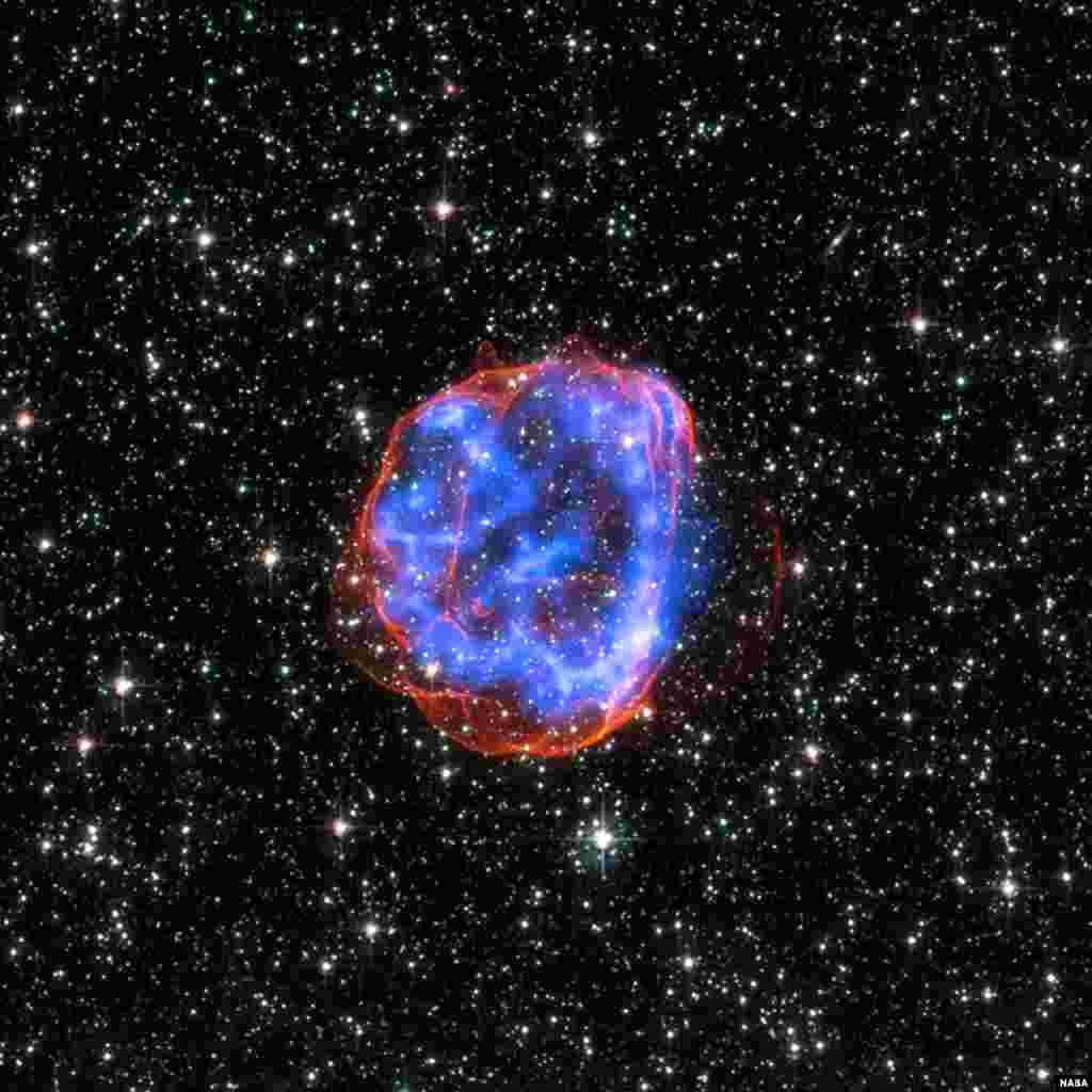 In this image, an expanding shell of debris called SNR 0519-69.0 is left behind after a massive star exploded in the Large Magellanic Cloud, a satellite galaxy to the Milky Way. Multimillion degree gas is seen in X-rays from Chandra, in blue. The outer ed