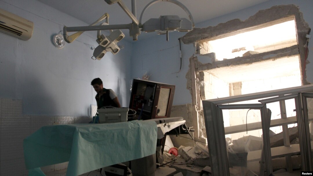 FILE - A medic inspects the damage inside Anadan Hospital, sponsored by Union of Medical Care and Relief Organizations, after it was hit by an airstrike in the rebel-held city of Anadan, northern Aleppo province, Syria, July 31, 2016.