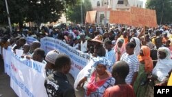 People holding banners take part in a protest called by the Coordination of Patriotic Organizations in Mali (COPAM) against a foreign military intervention in Mali to reclaim the Islamist-controlled north, September 28, 2012.