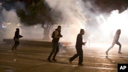 Israel's mainly Jewish Ethiopians clash with Israeli riot police during a protest against racism and police brutality in Tel Aviv, Israel, Sunday, May 3, 2015.