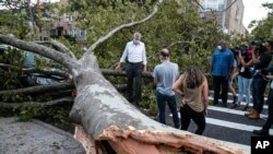 New York City Mayor Bill de Blasio talks with residents about damage from Tropical Storm Isaias, Aug. 4, 2020, in the Queens borough of New York.