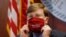 Mississippi Gov. Tate Reeves adjusts his "Make America Great Again," face mask upon concluding his press briefing with members of the state's COVID-19 response team, to discuss the ongoing strategy to reduce and limit transmission, July 20, 2020, 