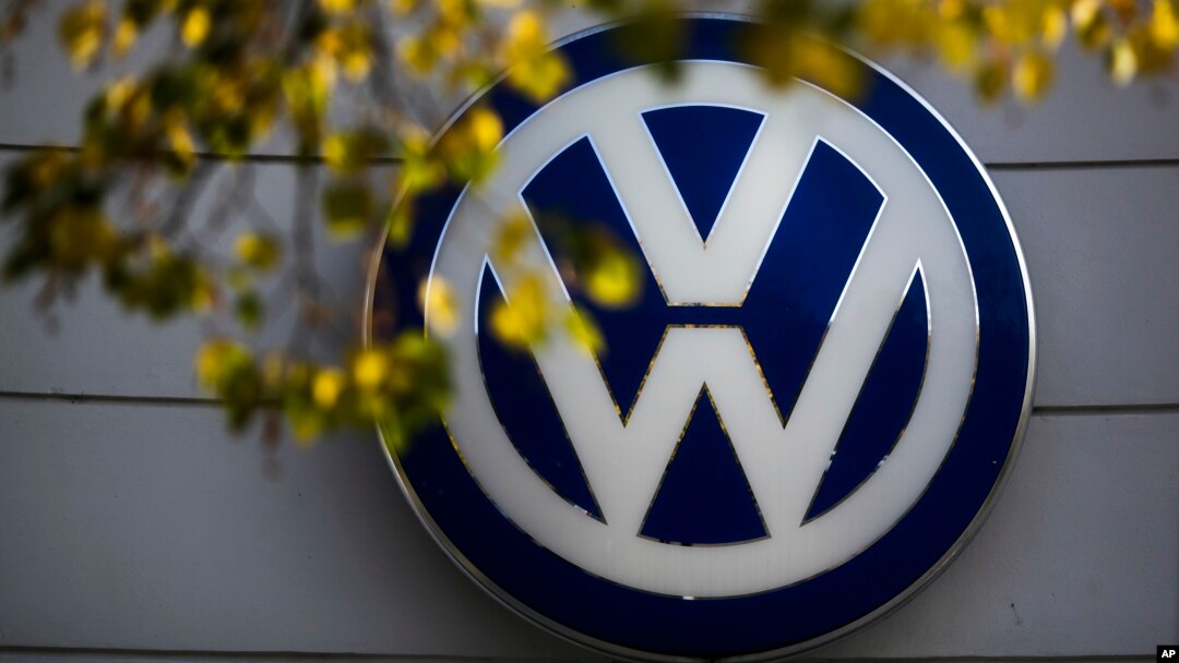 FILE - The VW sign of Germany's car company Volkswagen is displayed at the building of a company's retailer in, Berlin, Germany. 