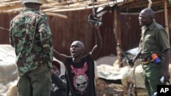 FILE: A man gestures to police in Kibera slums as police clash with demonstrators during a protest by supporters of Kenya's opposition leader Raila Odinga over the high cost of living and alleged stolen presidential vote, in Nairobi,. Taken Mon., March 20, 2023.