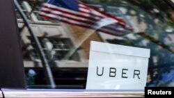 An Uber sign is seen in a car in New York. 