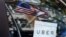 FILE - An Uber sign is seen in a car in New York, June 30, 2015. 