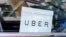 An Uber sign is seen in a car in New York, June 30, 2015. Members of metered taxi associations in South Africa said the online app competes unfairly for business.