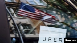 An Uber sign is seen on a car in New York City. 