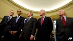 President George W. Bush hosts President-elect Barack Obama, and former presidents, from left, George H.W. Bush, Bill Clinton and Jimmy Carter, Jan. 7, 2009, in the Oval Office of the White House in Washington.