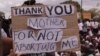 A protester holds a placard during anti-abortion protests in Lilongwe, Malawi, Dec. 6, 2016. (L. Masina/VOA)