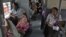 Train passengers wait for electricity to be restored at a railway station in the northern Indian city of Allahabad, July 30, 2012.