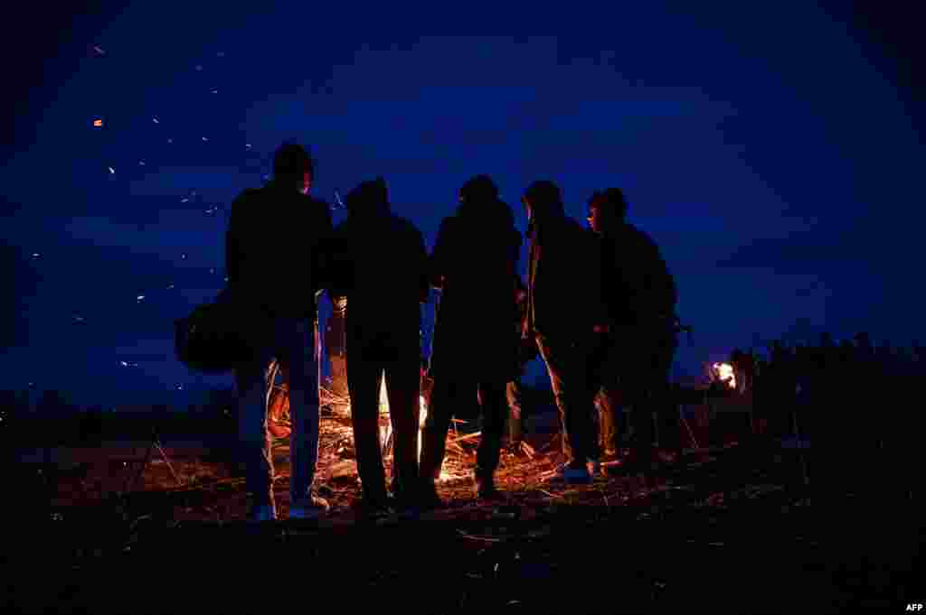 Migrants light a fire while camping along the Turkey-Greece border near Pazarkule, in Edirne district. 