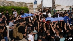 Mourners carry five Palestinian bodies during their funeral in Tubas, West Bank, Sept. 5, 2024. They were killed in an Israeli strike overnight, Palestinian health officials said. Another fighter was killed in an airstrike on the Al-Faraa refugee camp.