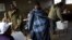 A Lesotho man wearing a traditional blanket prepares to vote at the Mpho primary school in Maseru, Lesotho, May 26, 2012.