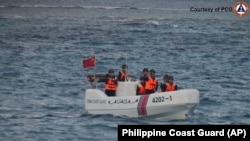 A Chinese Coast Guard boat sails around Sandy Cay in the South China Sea, Jan. 24, 2025. 