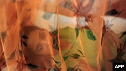 A patient with dengue rests under netting at a hospital in Allahabad, India. The mosquito-borne disease often is a greater priority than melioidosis, which a new study finds is more widespread and dangerous than previously believed. 