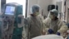 FILE -Nurses attend to a patient in the COVID-19 intensive care unit, at Providence Saint Joseph Medical Center in Burbank, California, November 19, 2020.