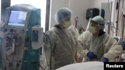 FILE -Nurses attend to a patient in the COVID-19 intensive care unit, at Providence Saint Joseph Medical Center in Burbank, California, November 19, 2020.