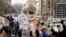 FILE - People hold the March for Our Lives rally in Washington in support of gun control, March 24, 2018. It's far from certain that the young people behind the movement will be a political force at the ballot box this fall. 