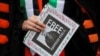 A demonstrator holds a sign during a protest at the University of California Los Angeles (UCLA), following the arrest in New York by U.S. immigration agents of Palestinian student protester Mahmoud Khalil, in Los Angeles, California, March 11, 2025.