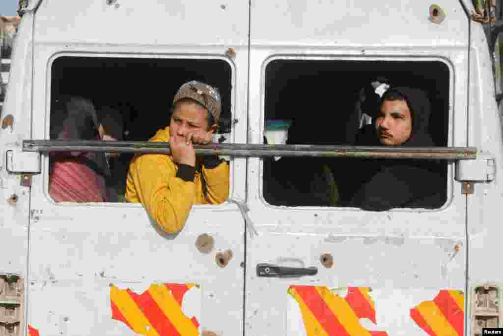 Palestinians travel in a vehicle following a delay in the ceasefire between Israel and Hamas over the hostage list, in Gaza City, Jan. 19, 2025. 