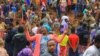 This grab made from a handout footage released by the Gofa Zone Government Communication Affairs Department on July 23, 2024, shows people standing at the bottom of a landslide that occurred in the Geze-Gofa district.