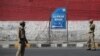 Indian policemen stand guard outside the residence of National Conference president Farooq Abdullah in Srinagar, Indian controlled Kashmir, Sept. 16, 2019. 