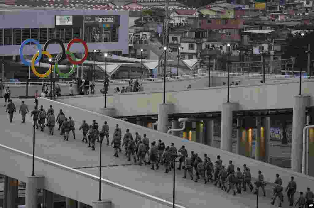 Soldados passam pelos anéis olímpicos no estádio do Maracanã para a abertura dos Jogos Olímpicos 2016 no Rio de Janeiro, Brasil, Ago. 5, 2016.