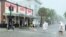 Determined visitors head for Sloppy Joe's Bar while crossing a flooded Duval Street as heavy winds and rain pass over Key West, Fla., July 6, 2021.
