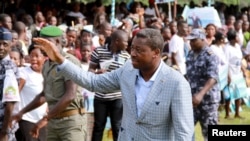 Incumbent President Faure Gnassingbe, who is running for a third term, waves to a crowd at a campaign rally in Tado, Togo, April 13, 2015.