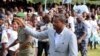 Incumbent President Faure Gnassingbe, who is running for a third term, waves to a crowd at a campaign rally in Tado, Togo, April 13, 2015.