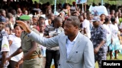 Incumbent President Faure Gnassingbe, who is running for a third term, waves to a crowd at a campaign rally in Tado, Togo, April 13, 2015.