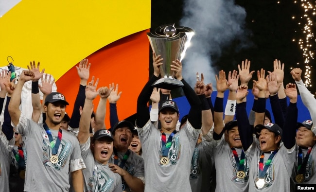 FILE - Shohei Ohtani (C) and team Japan celebrate with the World Baseball Classic trophy after defeating the U.S. in the World Baseball Classic at LoanDepot Park on March 21, 2023. (Rhona Wise-USA TODAY Sports)