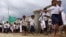 Cambodian schoolchildren walk on a muddy road near the dam site of Steung Mean Chey after they participated in an Intentional Children's Day event in the outskirts of Phnom Penh, file photo. 